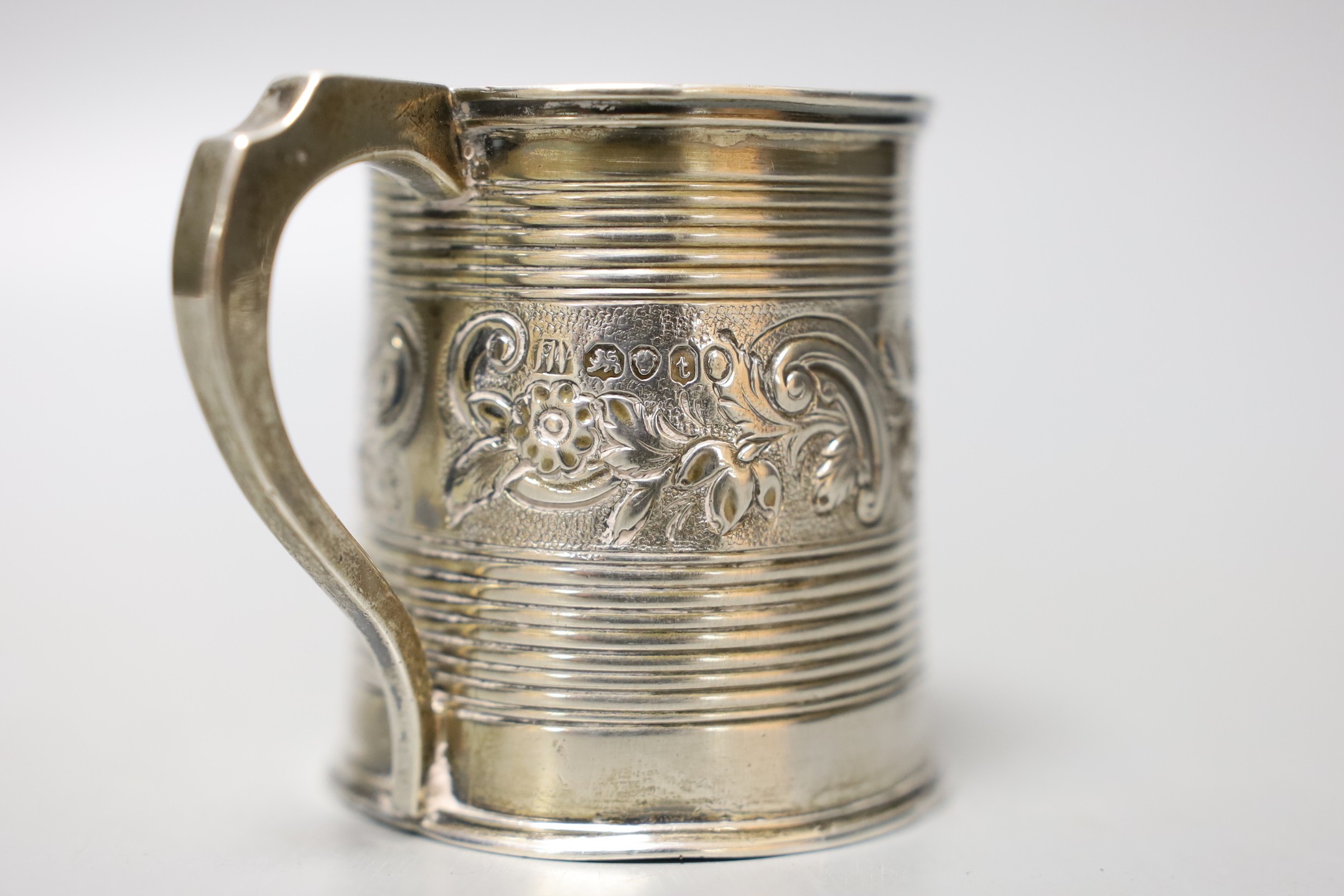 A William IV silver christening mug, with reeded and embossed decoration, London, 1834, 63mm, 98 grams